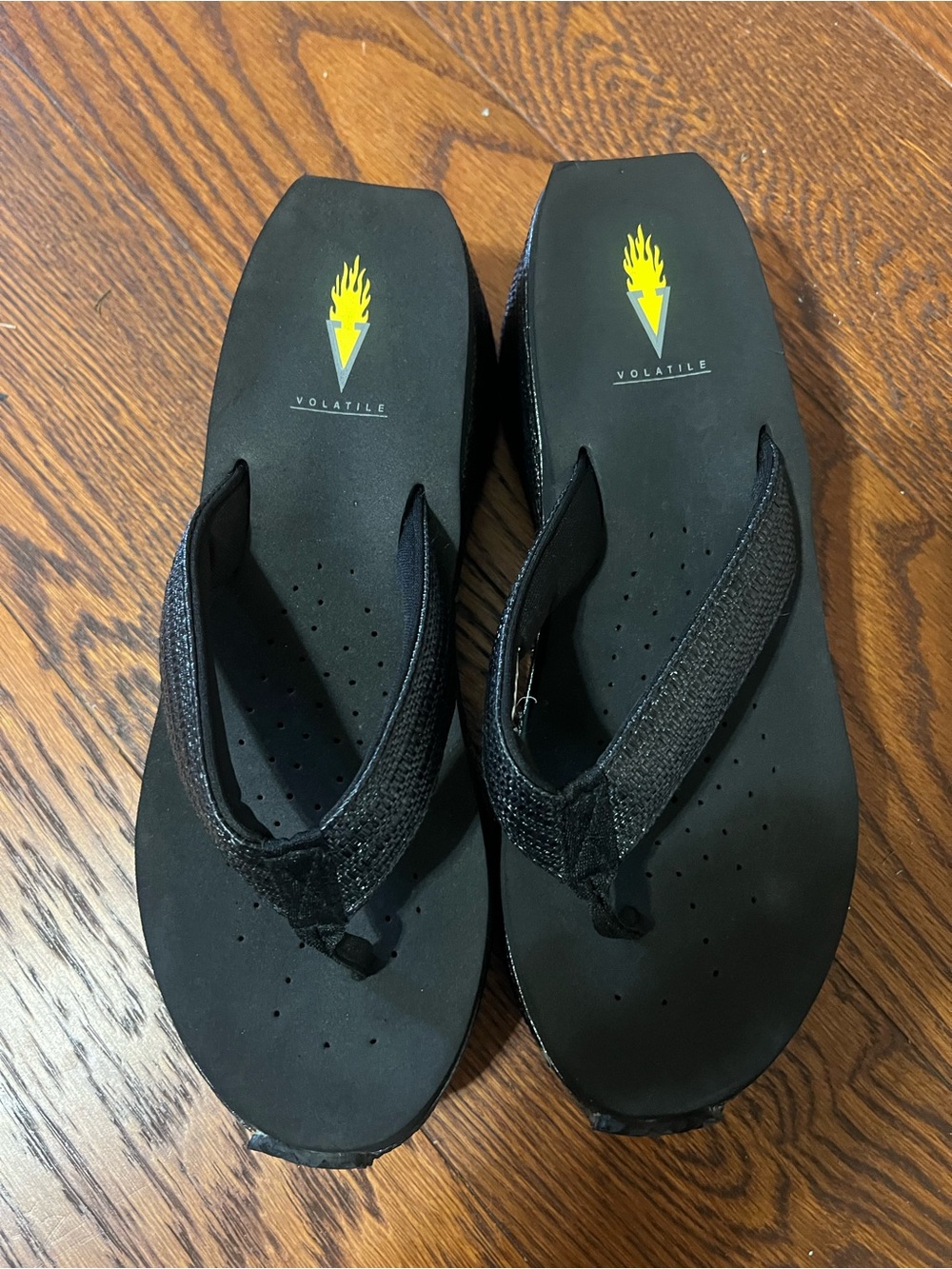 Volatile Black Flip Flop Sandals with Yellow Flame Logo